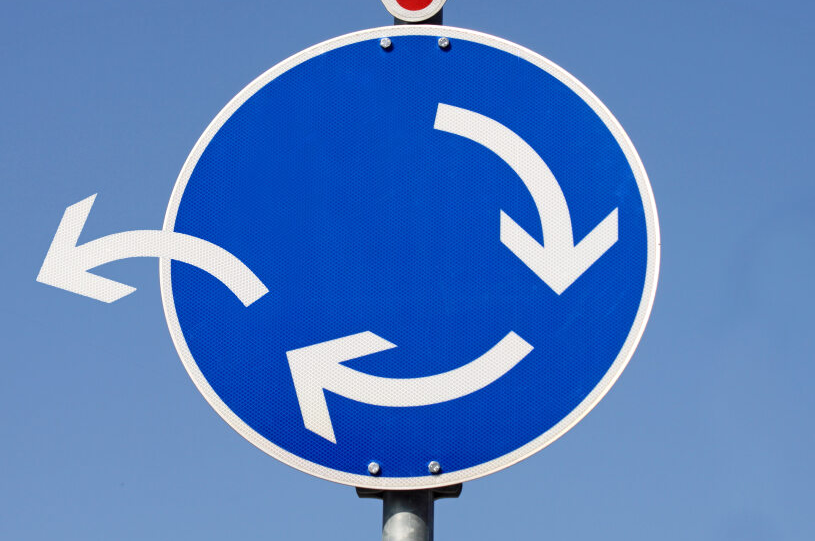 Roundabout sign, with one arrow veering away